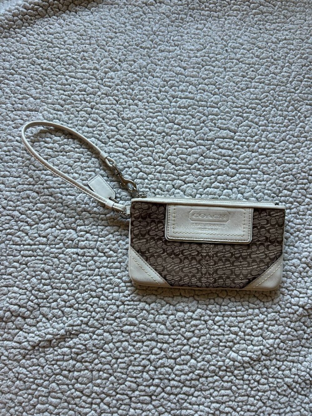 Coach -- brown signature C canvas wristlet, white leather trim, logo patch